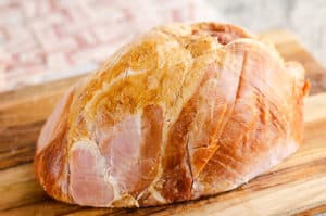 ham with crisscross scoring on cutting board
