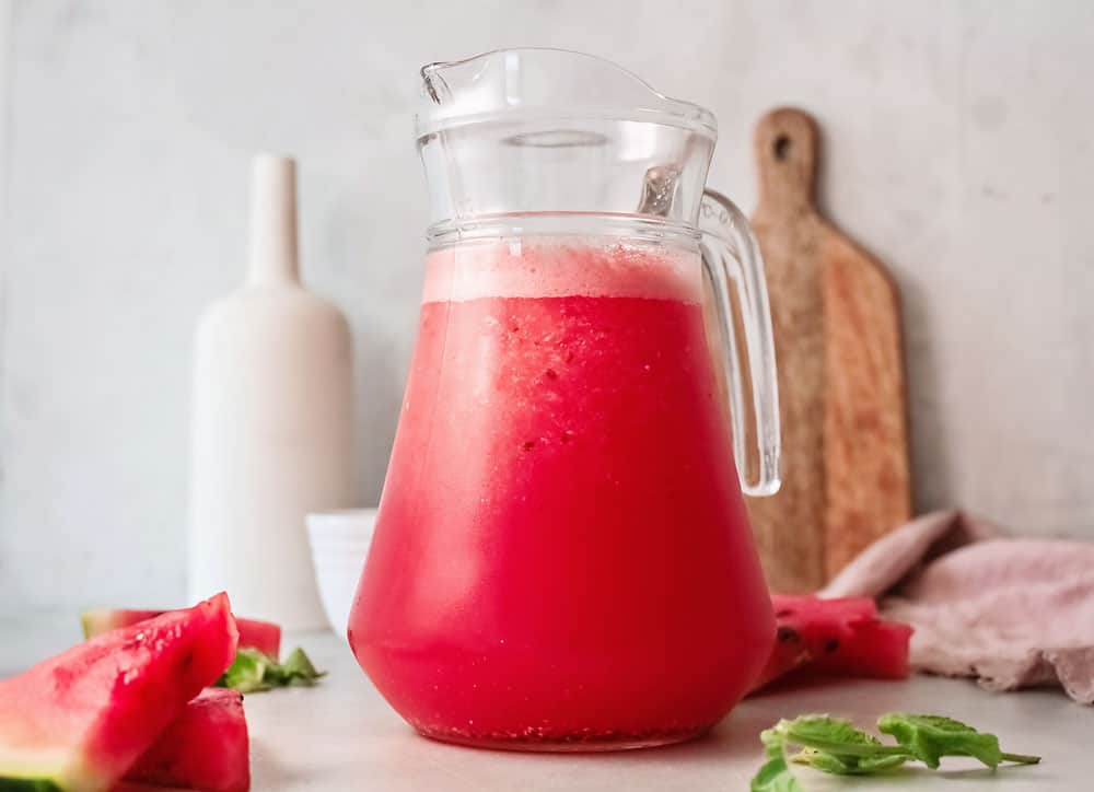 watermelon wine slushie in glass pitcher on table