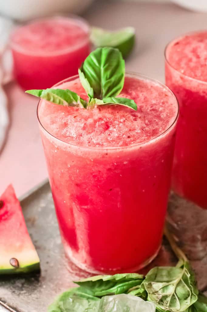 watermelon wine slushie on tray with ice and basil