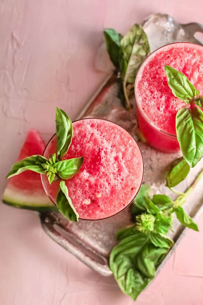 watermelon wine slushies garnished with basil leaves
