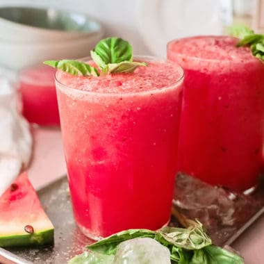 watermelon wine slushies on tray with watermelon wedges and ice