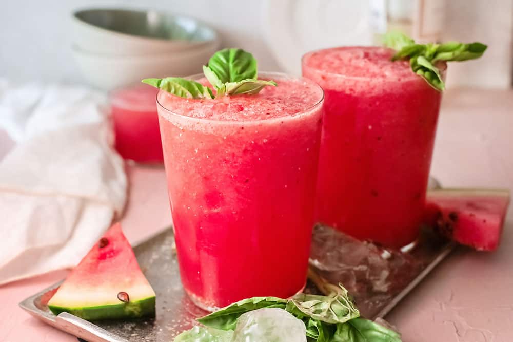 watermelon wine slushies on tray with watermelon wedges and ice