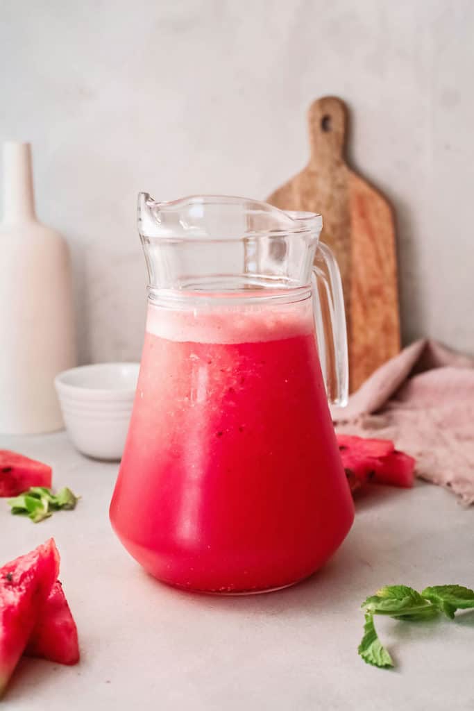 watermelon wine slushie in glass pitcher on table