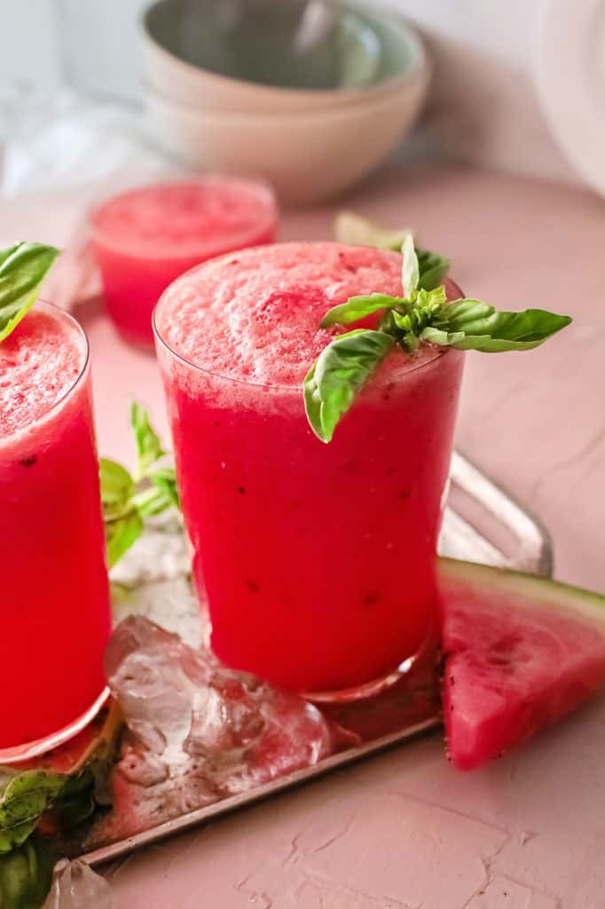 watermelon wine slushie on tray with ice and watermelon slice