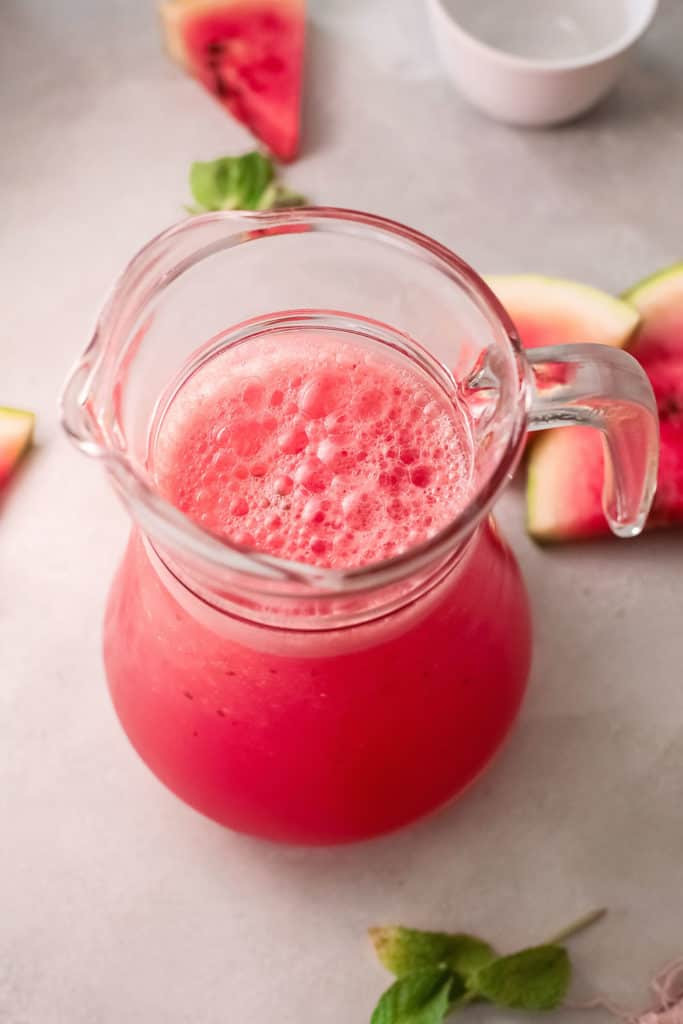 watermelon wine slushie in glass pitcher on table