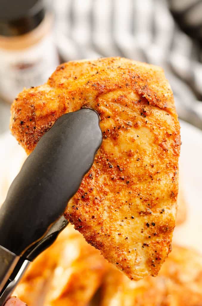 smoked chicken breast in tongs