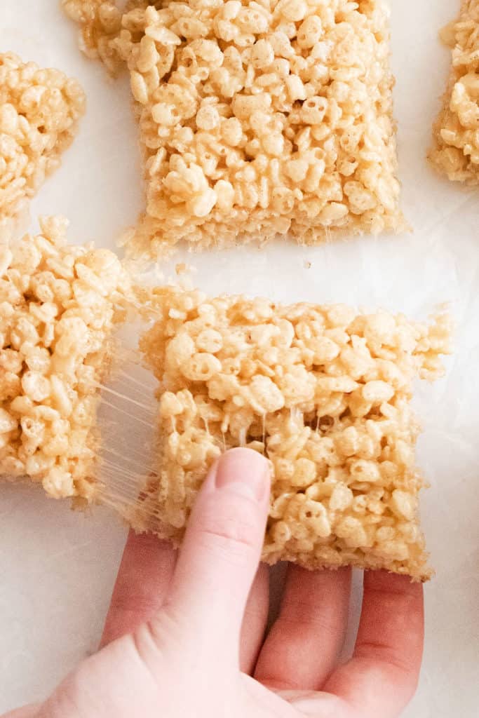 brown butter rice krispie treats pulled apart with hands