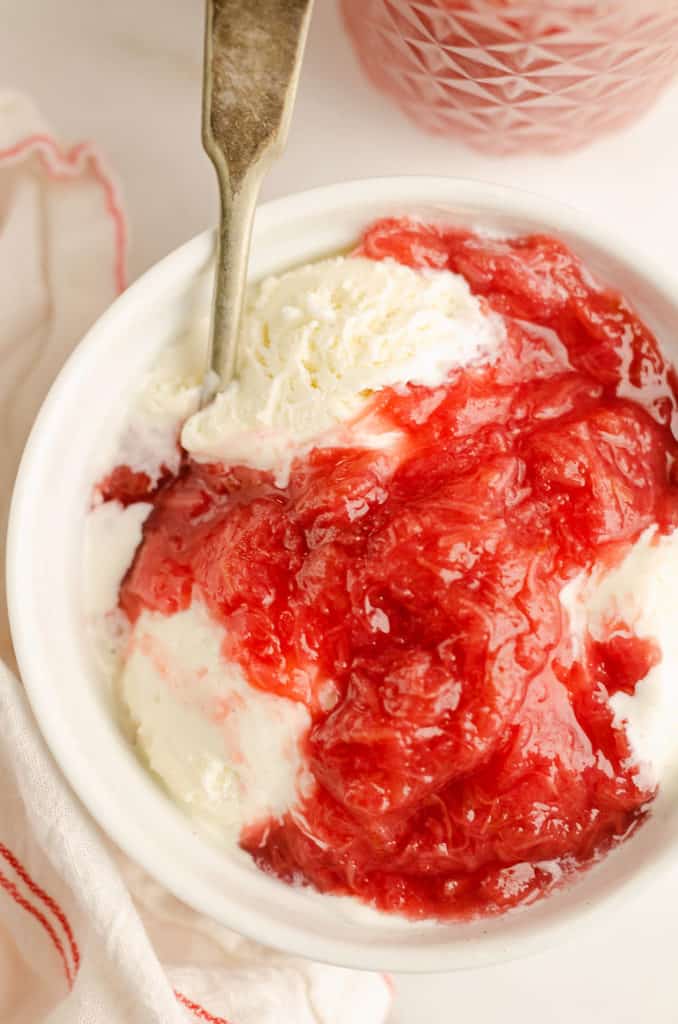 bowl of ice cream topped with rhubarb honey sauce