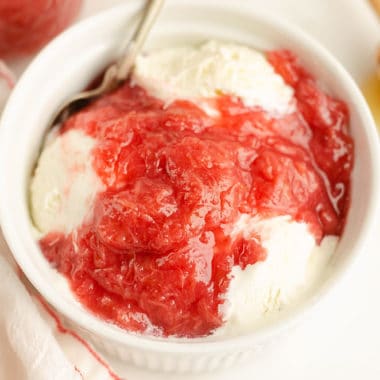 bowl of ice cream topped with rhubarb sauce