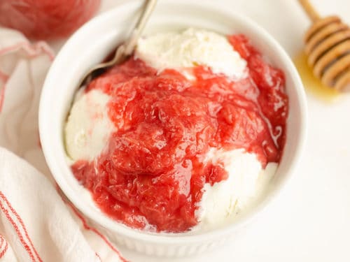 bowl of ice cream topped with rhubarb sauce