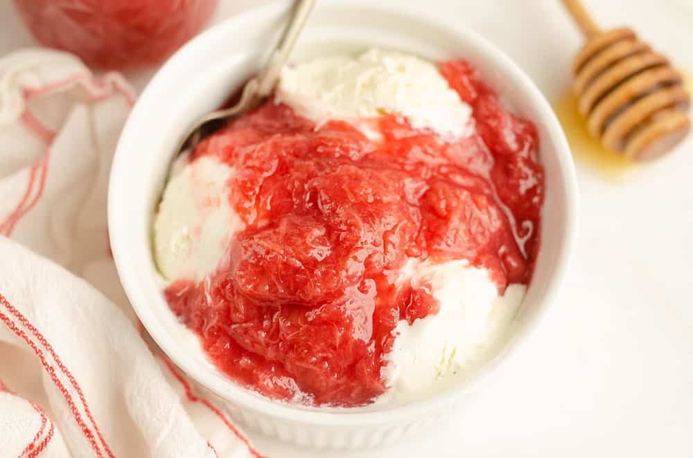 bowl of ice cream topped with rhubarb sauce