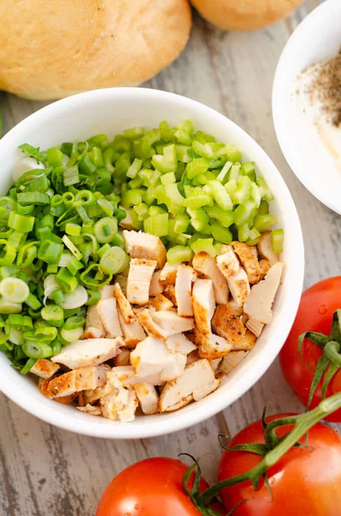 white bowl with diced smoked chicken, green onion and celery