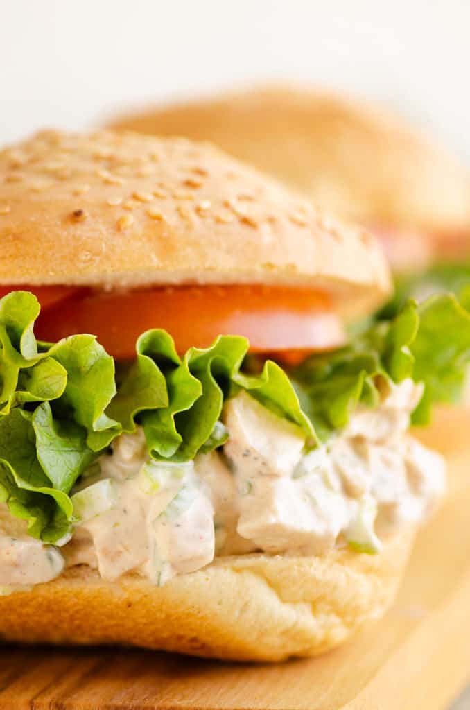 sesame bun with smoked chicken salad, lettuce and tomato slice