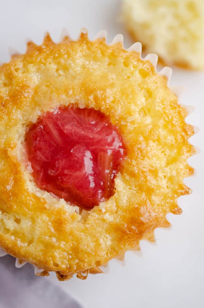 vanilla cupcake filled with rhubarb honey sauce in center