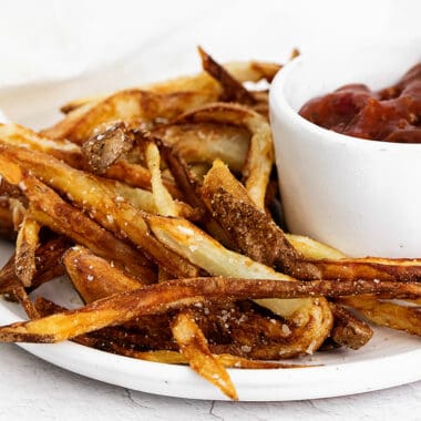 homemade french fries on plate with ketchup