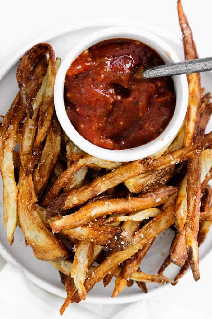 french fries on plate with ketchup