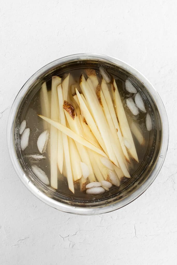 homemade french fries in ice bath bowl