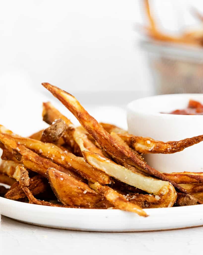 french fries on plate with ketchup