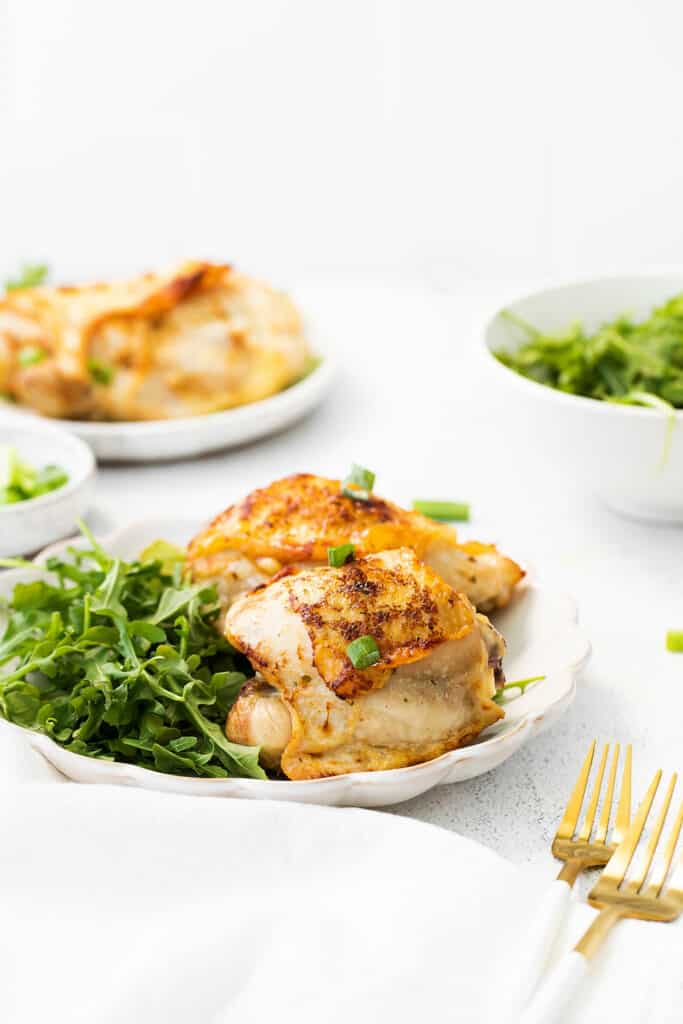 ranch chicken thighs on plate with salad