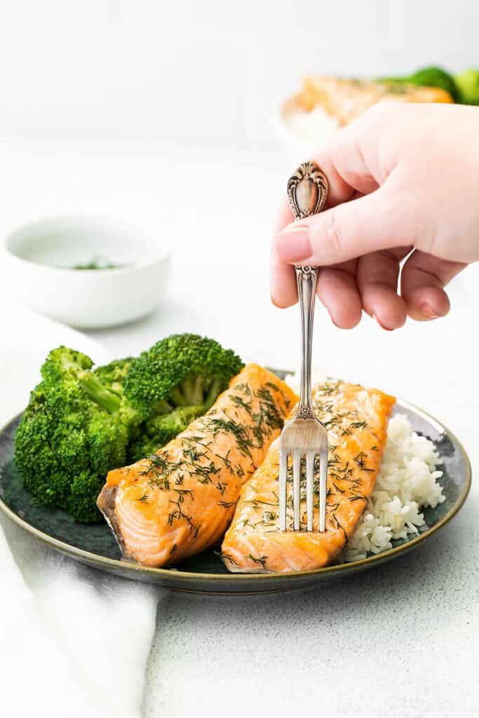 fork taking bite out of air fryer salmon fillets