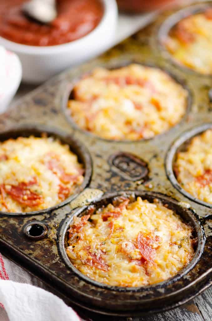 cheesy pizza rice muffins in muffin tin