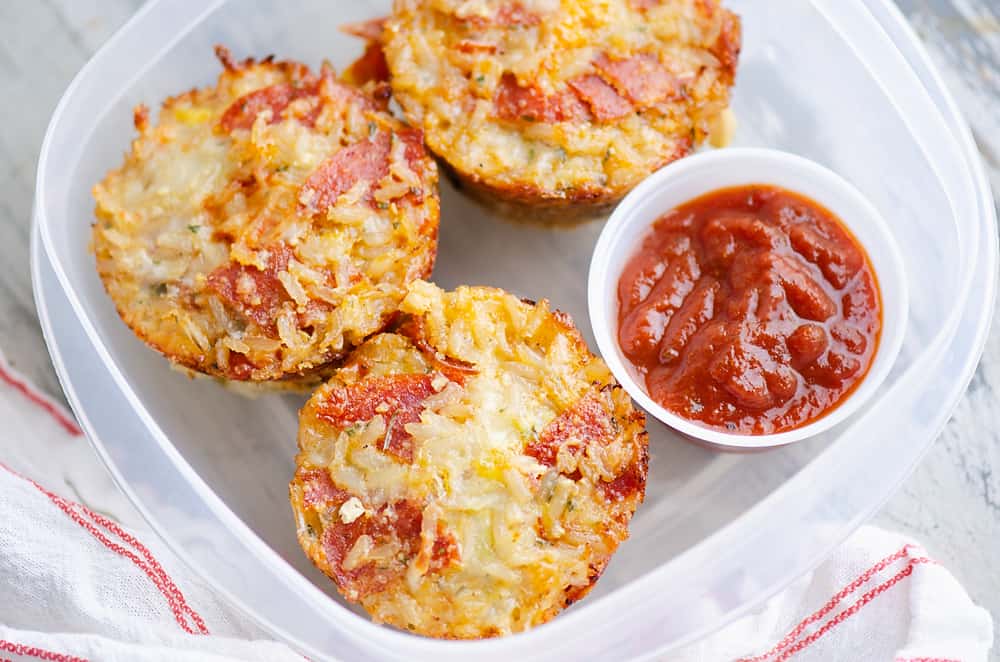 leftover pizza rice muffins stored in tupperware container with pizza sauce