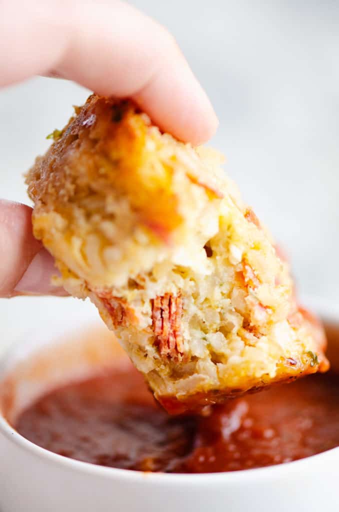 pizza rice muffin dunked in pizza sauce