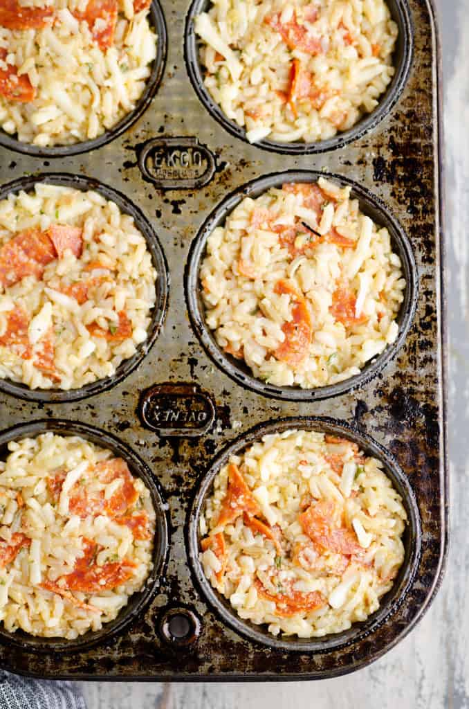 pizza rice muffins in muffin tin before baking
