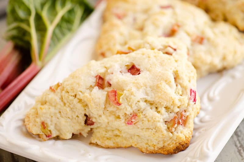 easy rhubarb scone on white platter with rhubarb stalk