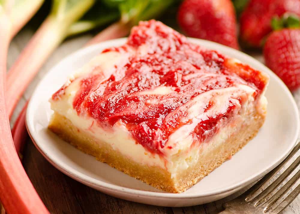 strawberry rhubarb cheesecake bar served on plate