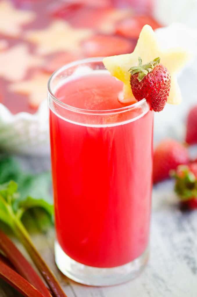 strawberry rhubarb punch in glass topped with pineapple star