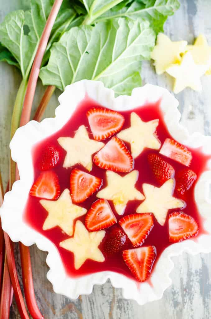 strawberry rhubarb punch in bowl with fresh pineapple stars