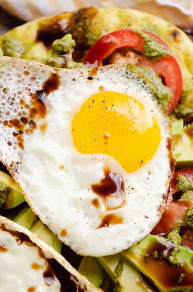 sunny side up egg drizzled with balsamic over flatbread