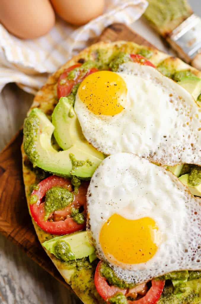 breakfast flatbread topped with sunny side up eggs