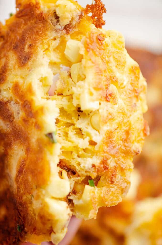 cheesy sweet corn fritter broken in half