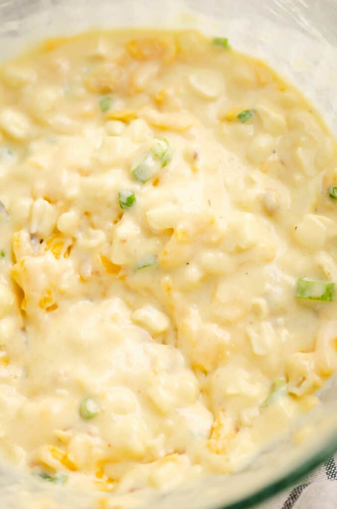 cheesy sweet corn fritter batter in glass bowl