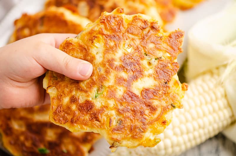 hand holding sweet corn fritter
