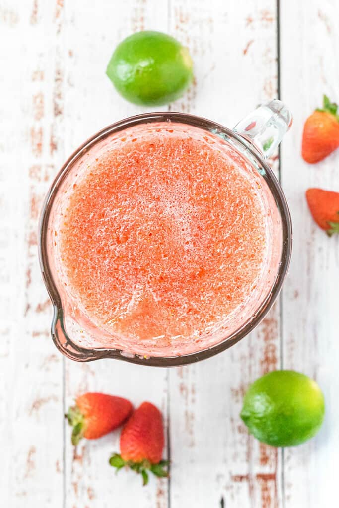 blender full of frozen strawberry daiquiris