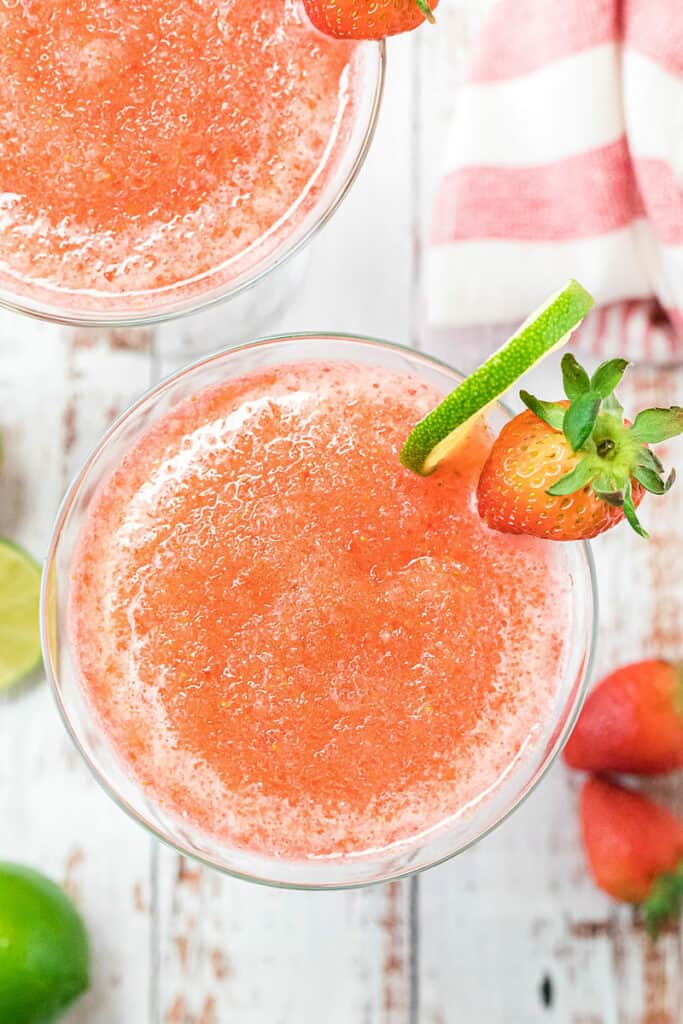 frozen daiquiri in glass with lime wedge