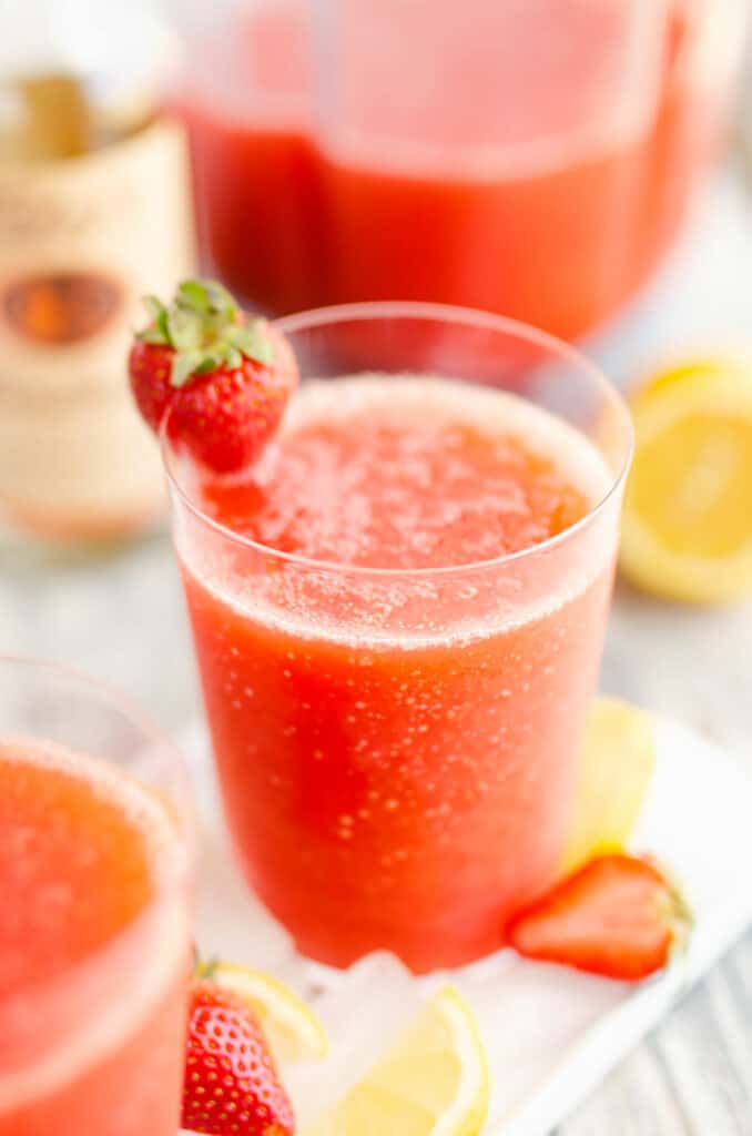 glass of frozen strawberry vodka lemonade with strawberry on ice