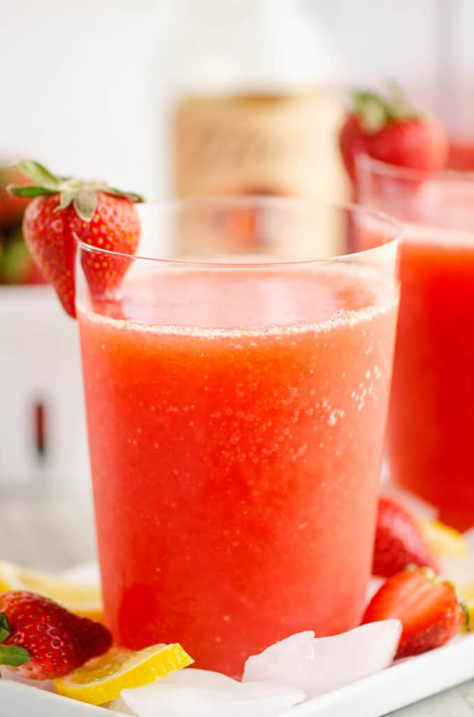 glass of frozen strawberry vodka lemonade topped with strawberry