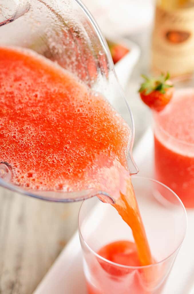 strawberry lemonade vodka slush poured in glass