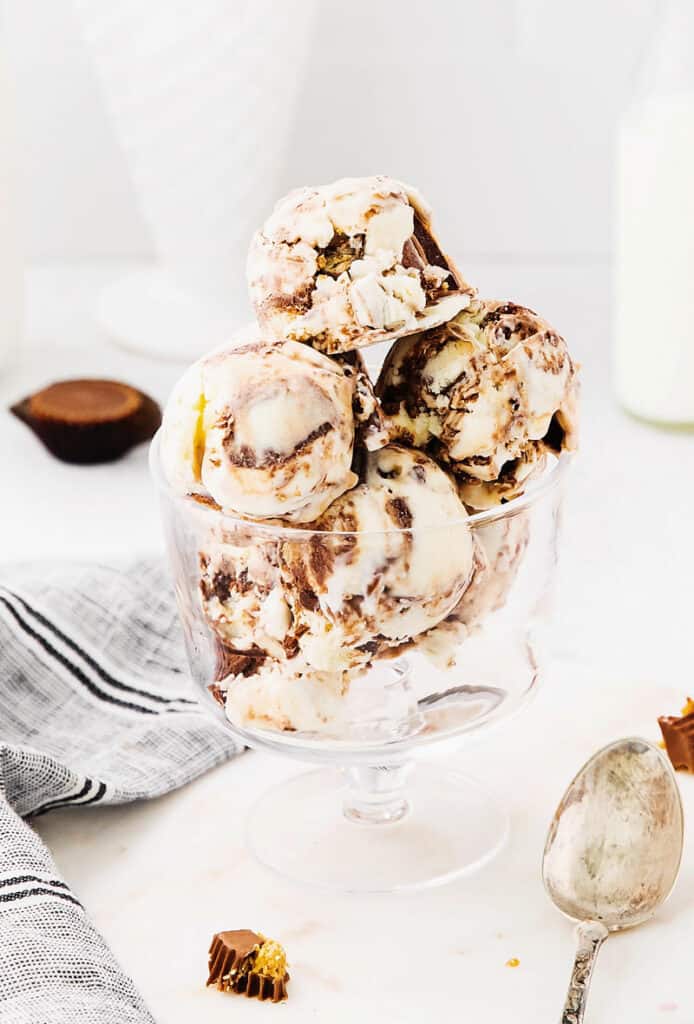 glass bowl full of fudge swirled ice cream