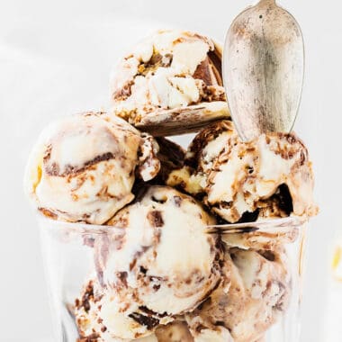 scoops of Moose Tracks ice cream in a glass scooped with spoon