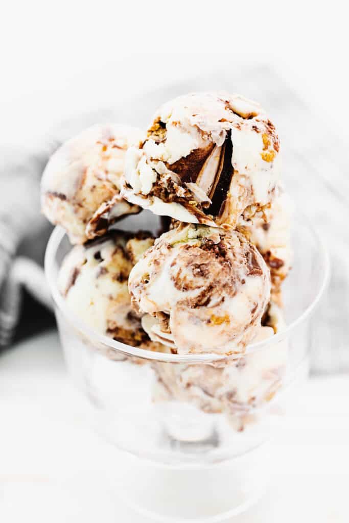 fudge swirled ice cream scoops in glass bowl