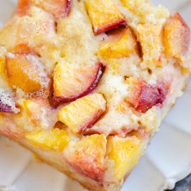 slice of peach custard dessert on scalloped plate