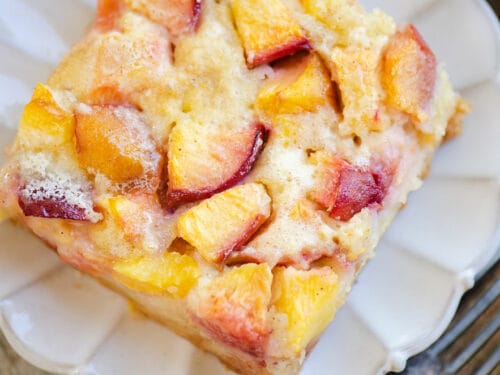 slice of peach custard dessert on scalloped plate