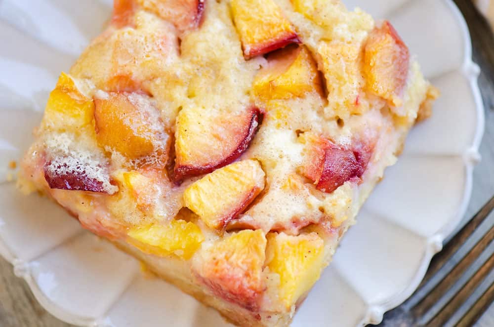 slice of peach custard dessert on scalloped plate