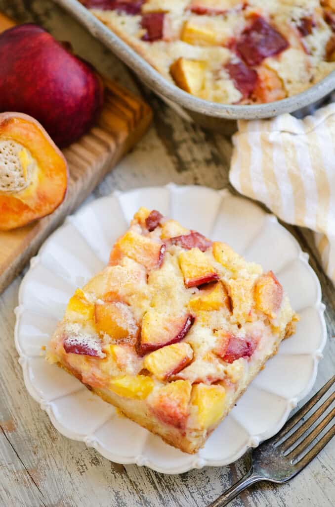 slice of easy peach custard dessert plated on table