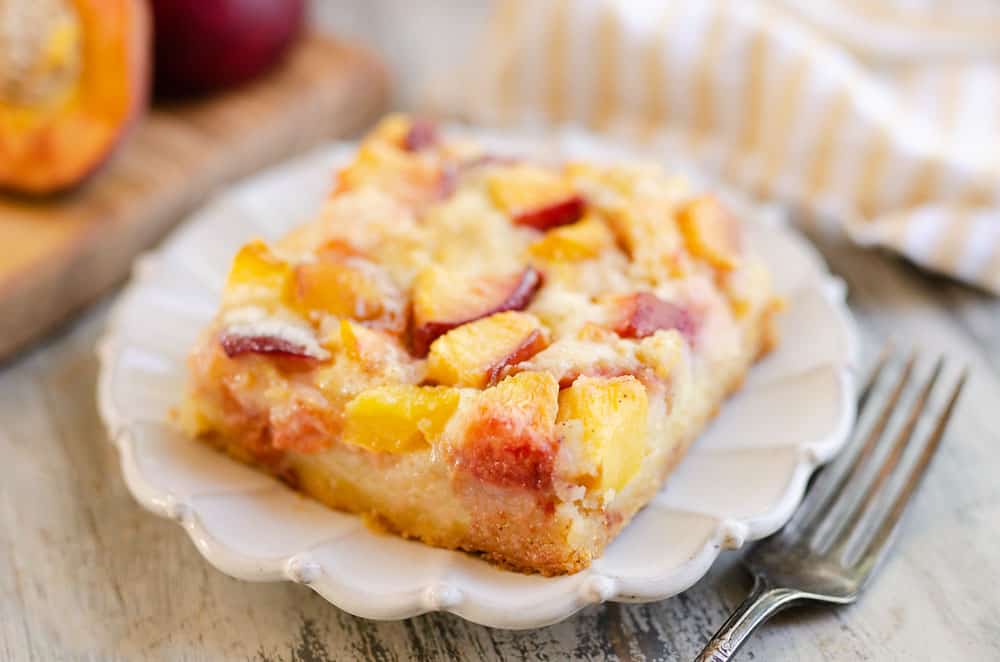 slice of peach custard dessert on plate with fork